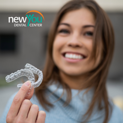 Woman holding clear aligners